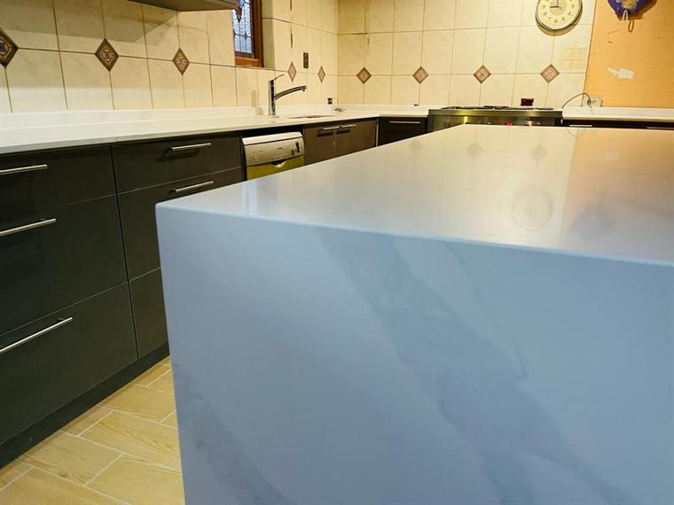 Isla de cocina con cubierta de cuarzo veteado en azul