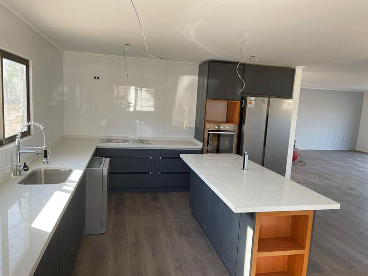 Cocina en U con isla central y cubierta clara